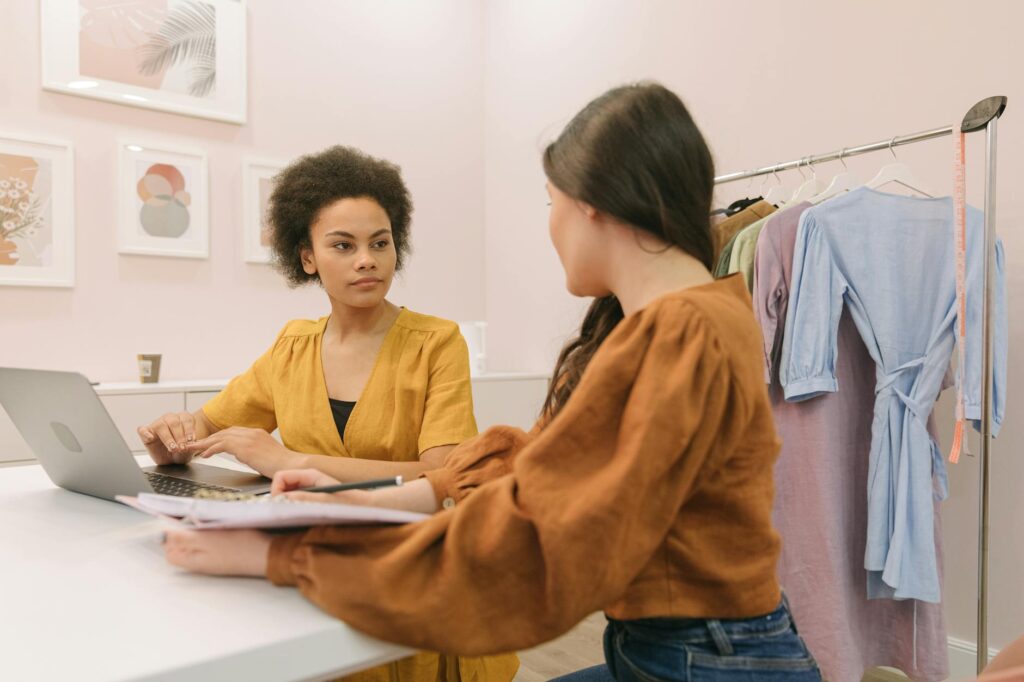 women sitting on a chair brainstorming together