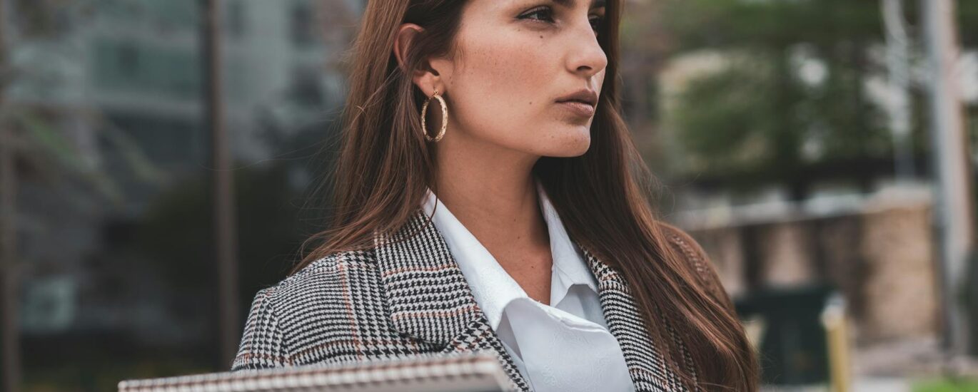 confident businesswoman standing outside building