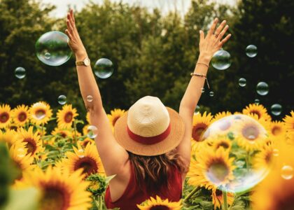 woman surrounded by sunflowers