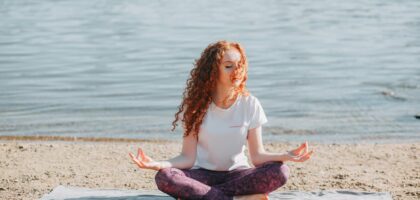 woman doing yoga exercise at the sea shore