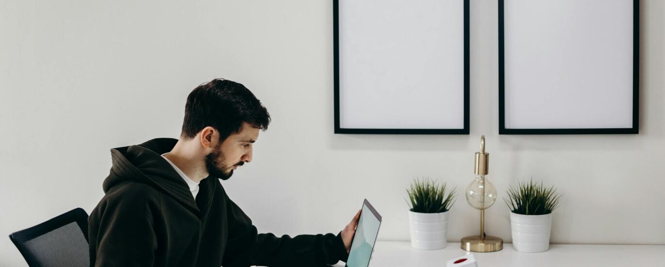 man in black coat sitting at the table